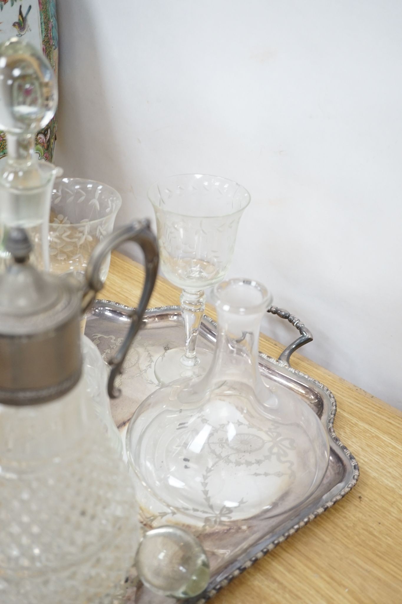 A plated two handled tea tray, a claret jug, two decanters and five glasses (9)